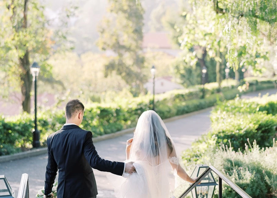 a man and woman walking down a bridge