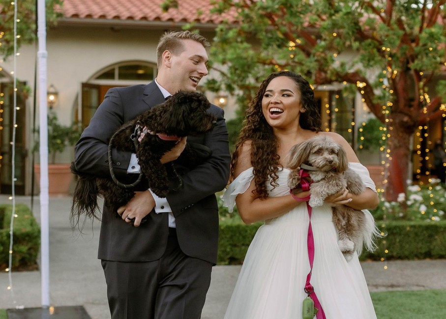 a man and woman holding a dog