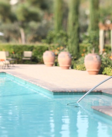 a pool with a person's hand coming out of the water