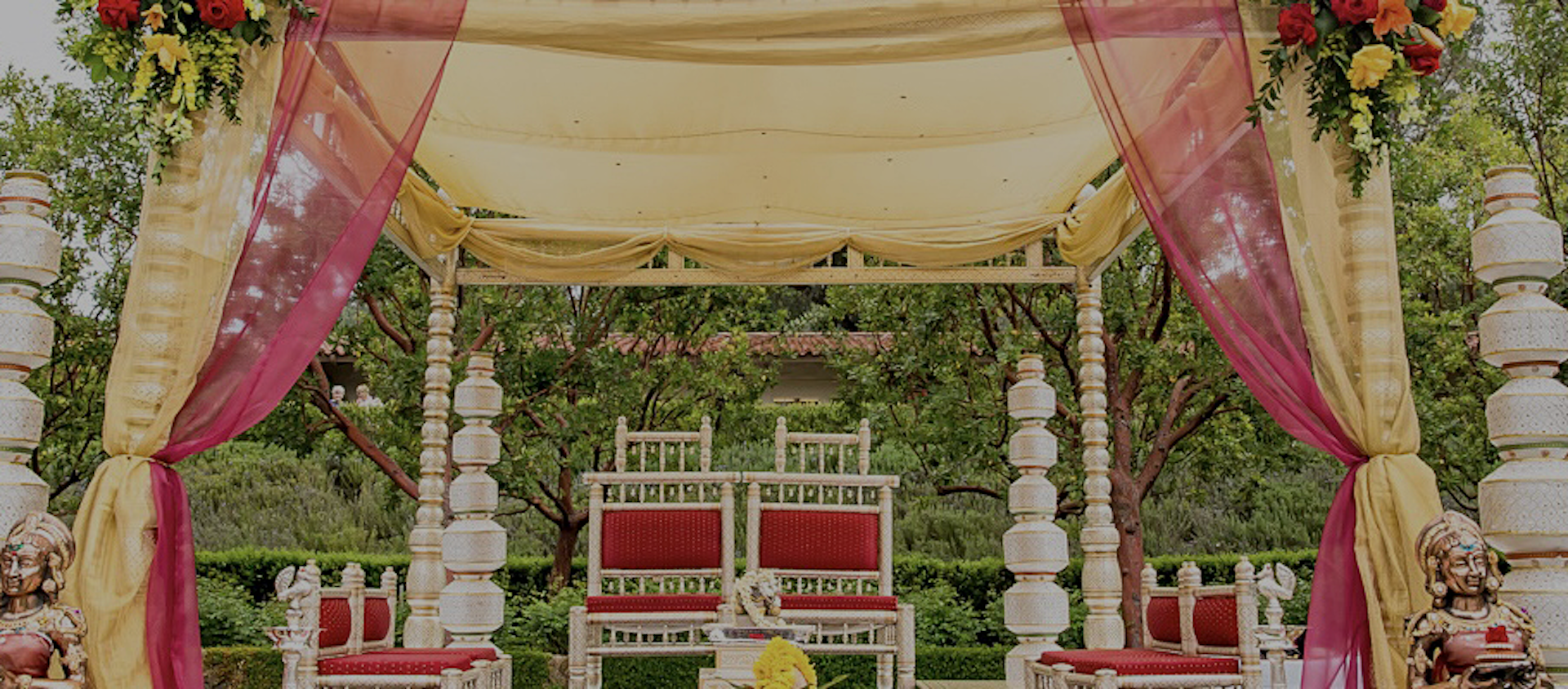 a white and red canopy with chairs and a table