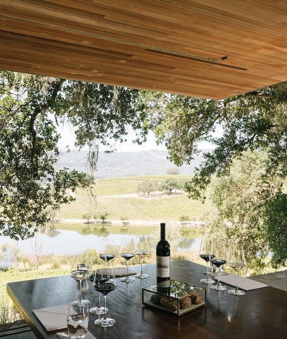 a table with wine glasses and a bottle of wine on it