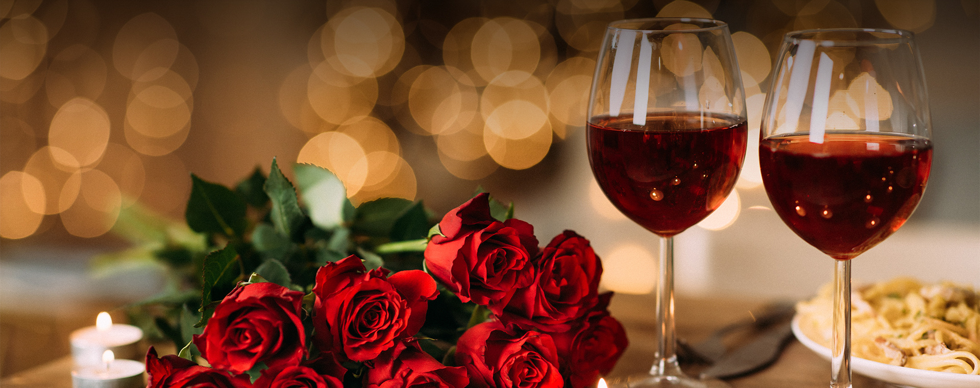 two glasses of wine and roses