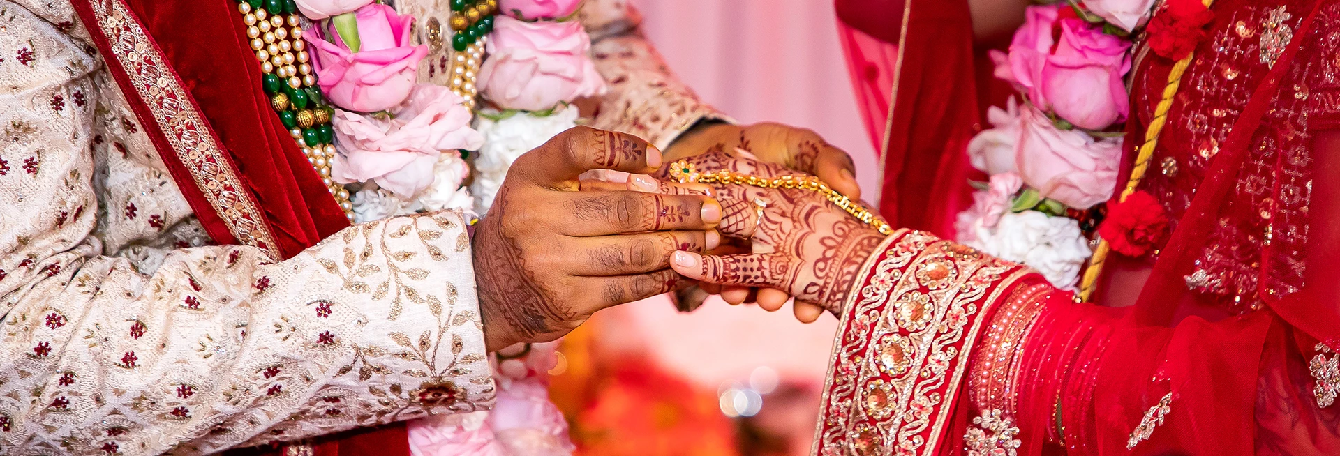 a person putting a bracelet on another person's hand