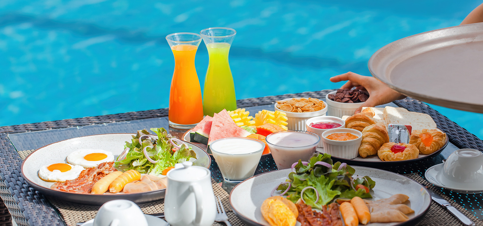 spread of platters with a view of the pool in background