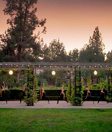 a group of people sitting on a bench in a park