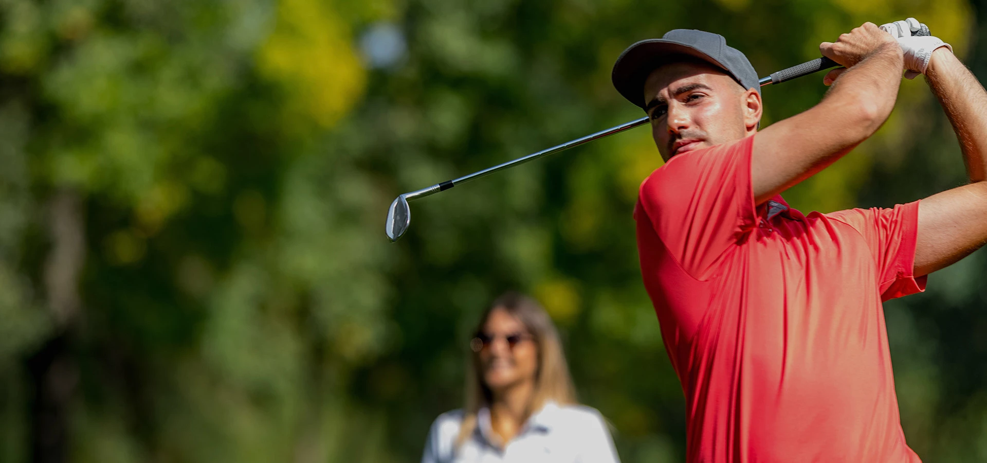 man swinging a golf club 