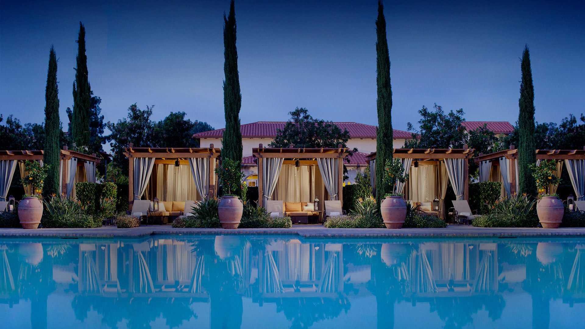 a pool with a building and trees