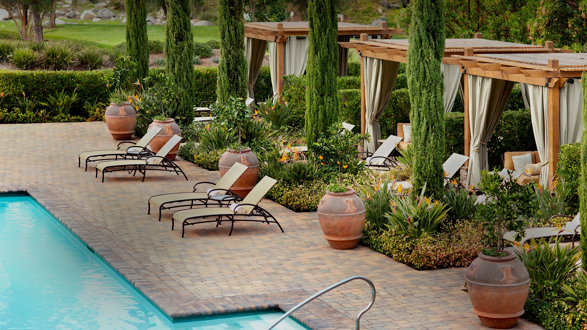 overhead view of the pool with a row of pool chairs