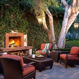 a patio with chairs and a fireplace
