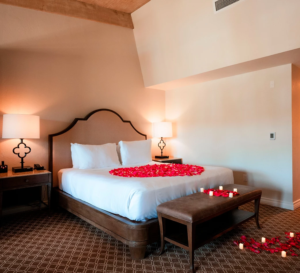 a bed with rose petals on it