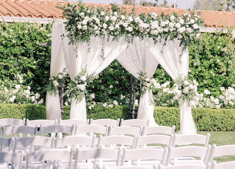 a large group of white chairs sit in a large room