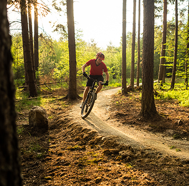 person bike riding on dirt path