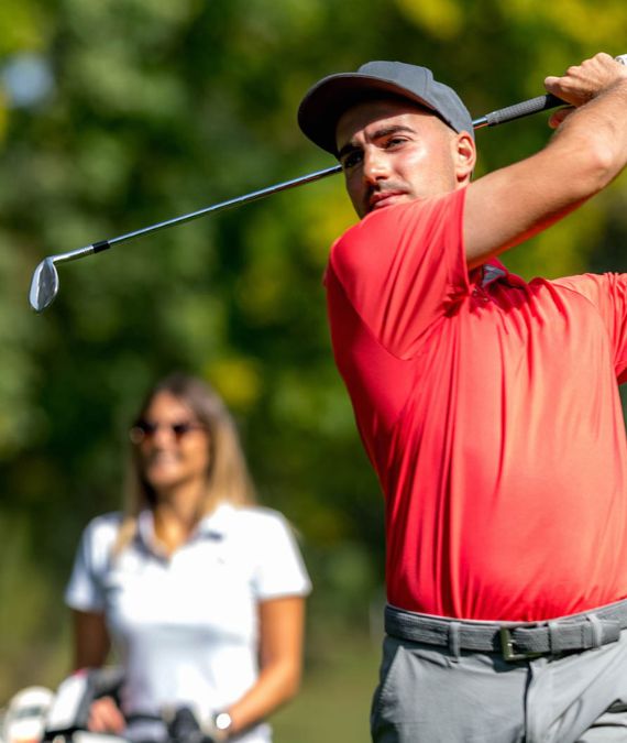 a man swinging a golf club