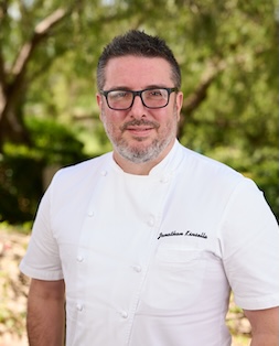 a man in a white chef's coat