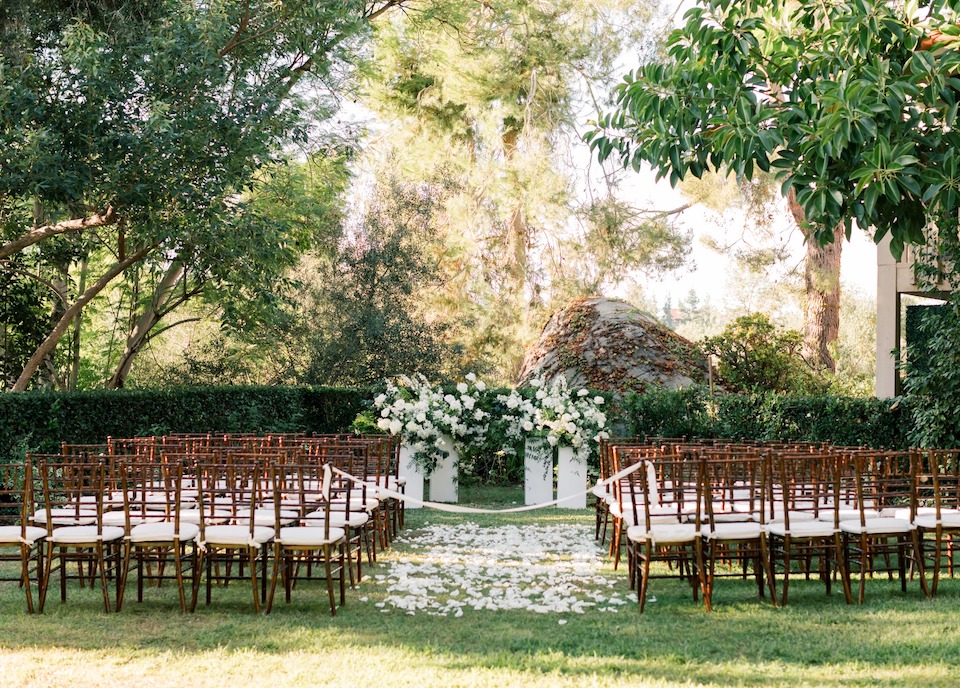 chairs in a garden with white chairs and flowers