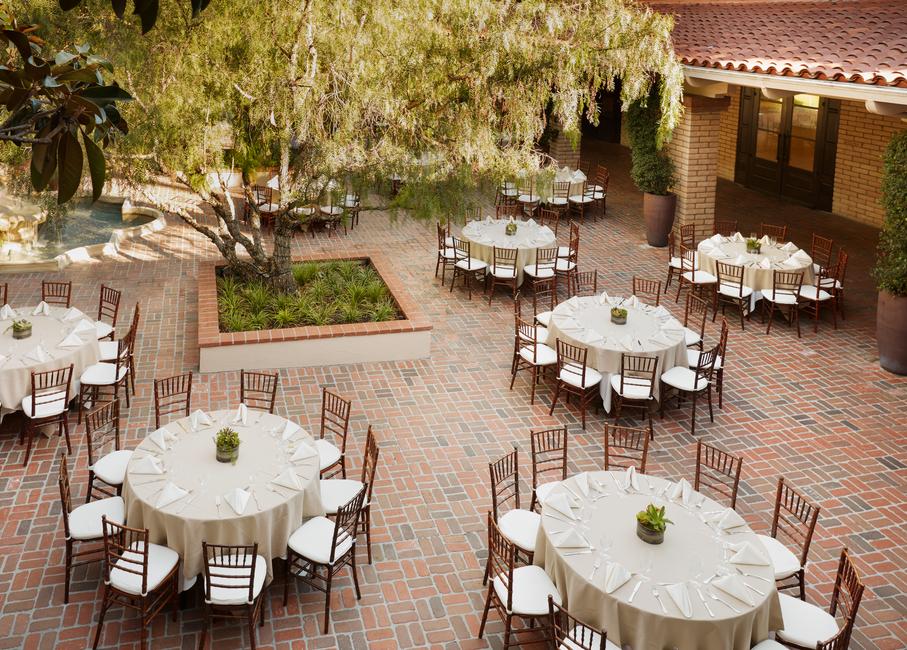 a courtyard with tables and chairs
