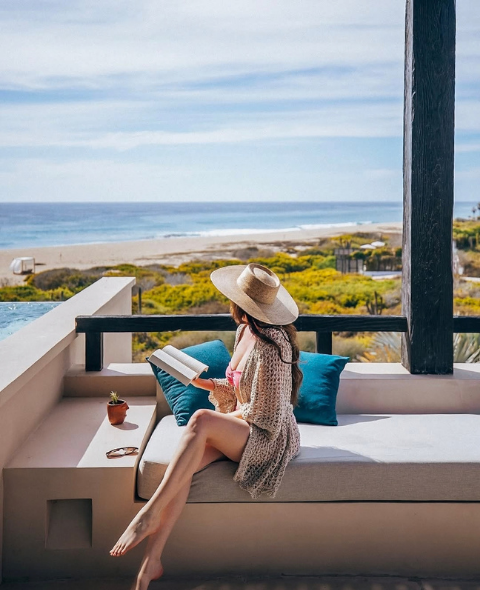 a woman sitting on a couch with a book