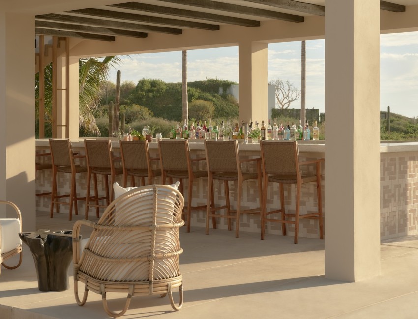 a patio with a bar and chairs
