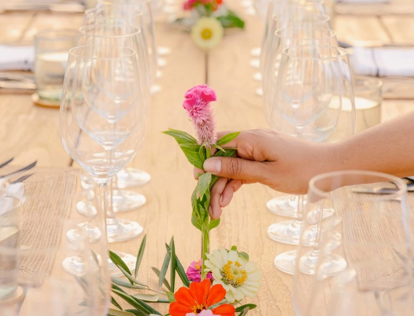 close up of a woman hand holding a flower arranging a bouquet