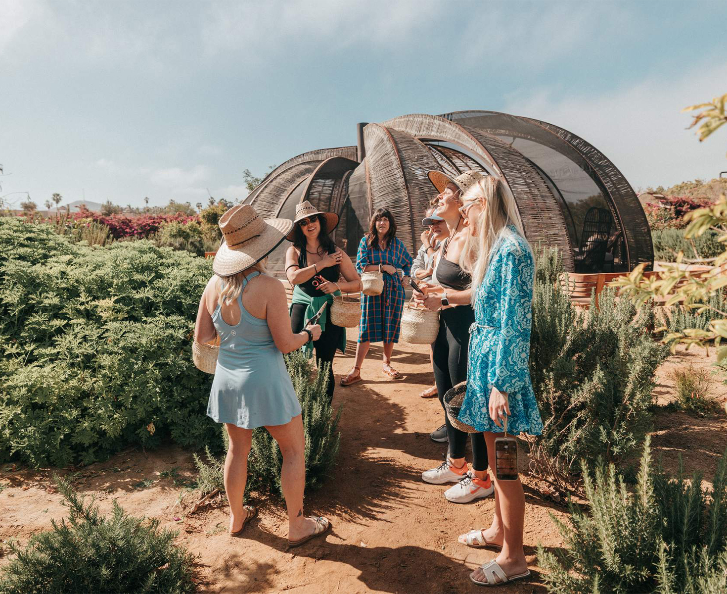 a group of women standing in a garden