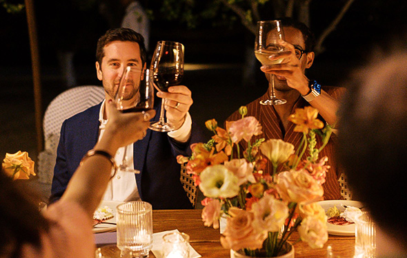 a group of people holding wine glasses at a table