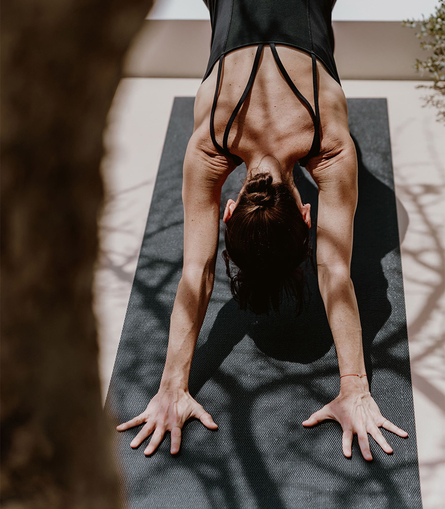 a woman doing yoga on a mat