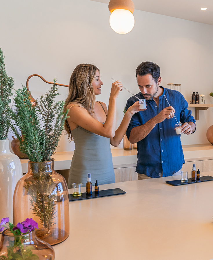 a man and woman standing in a kitchen