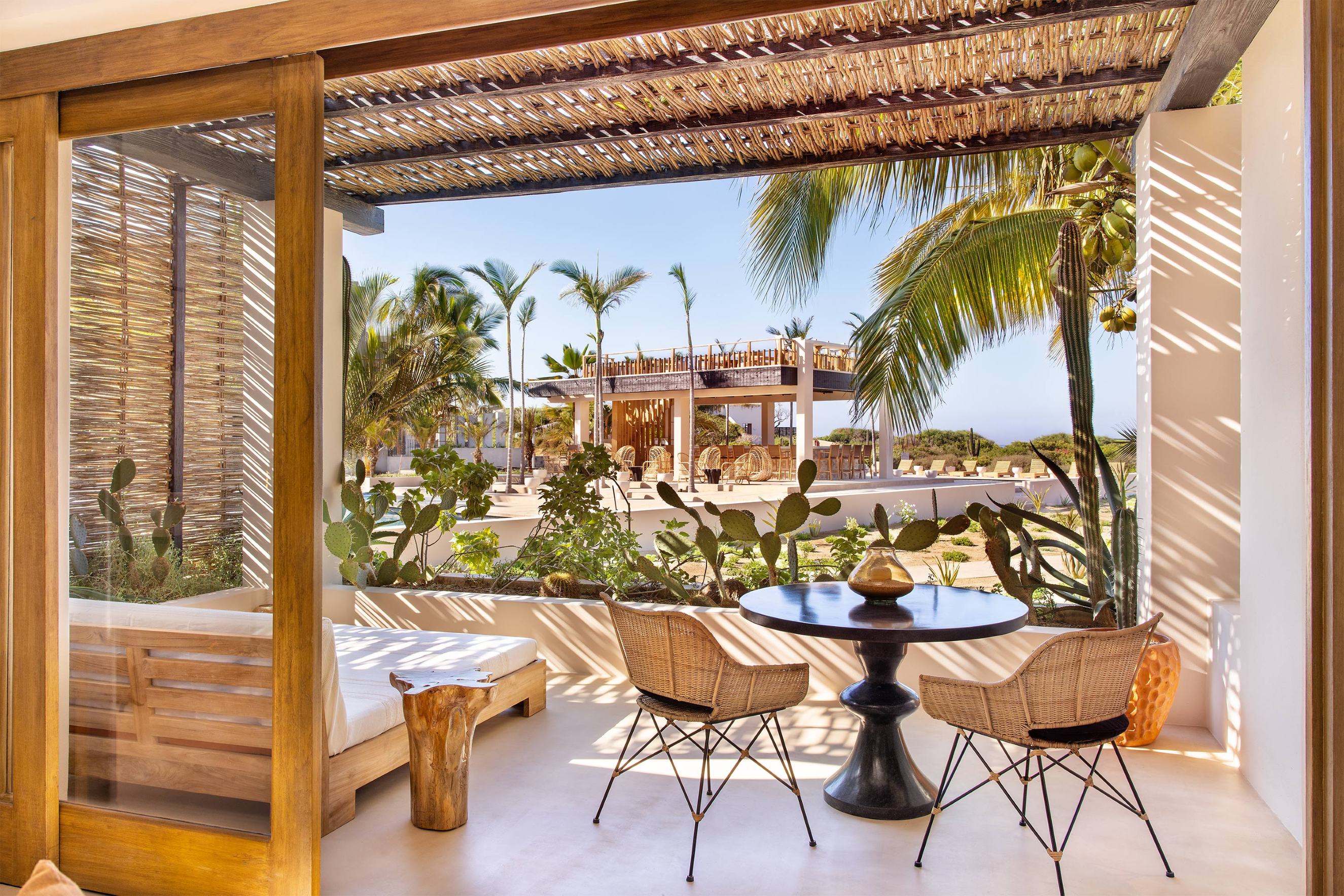 Mas Olas resort garden room patio view with a table and chairs