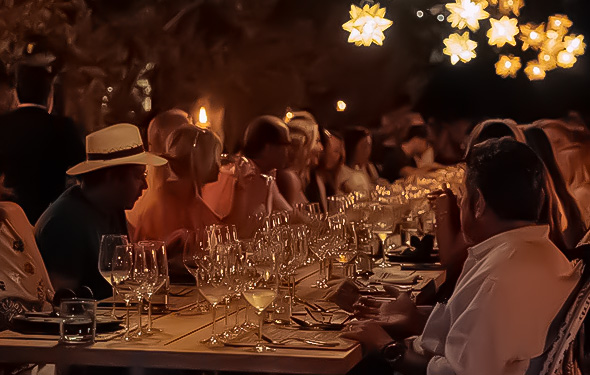 a group of people sitting at a table with wine glasses