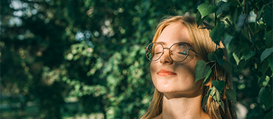 a woman with her eyes closed and glasses closed