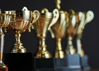 close up of small gold and black trophies