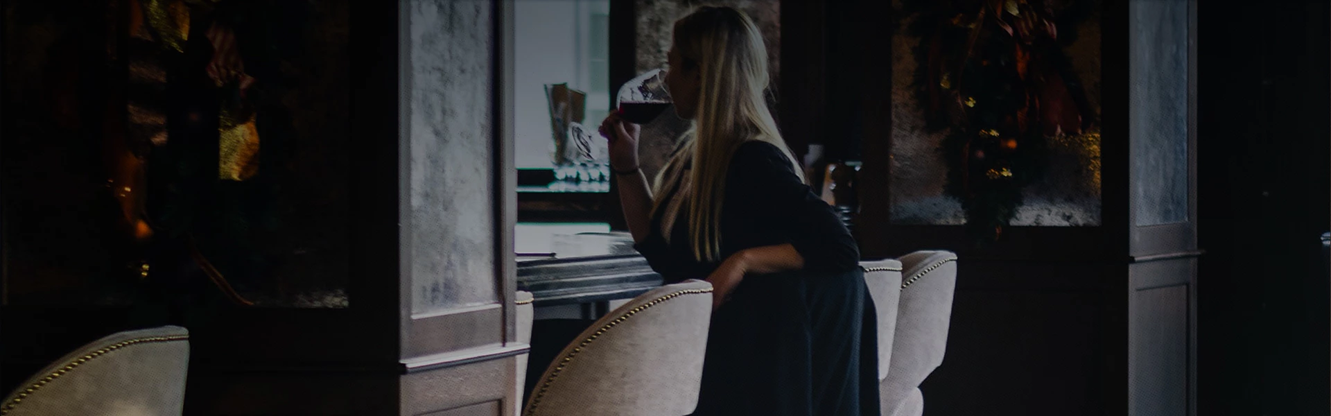 woman sitting alone at an upscale bar 