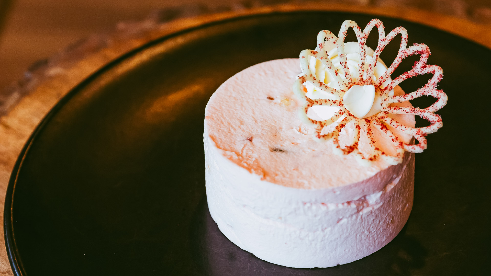 a white cake with a flower decoration on top
