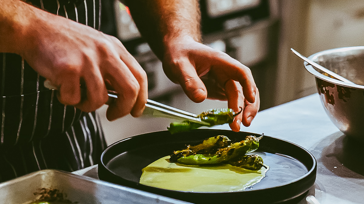 a person cooking food on a pan