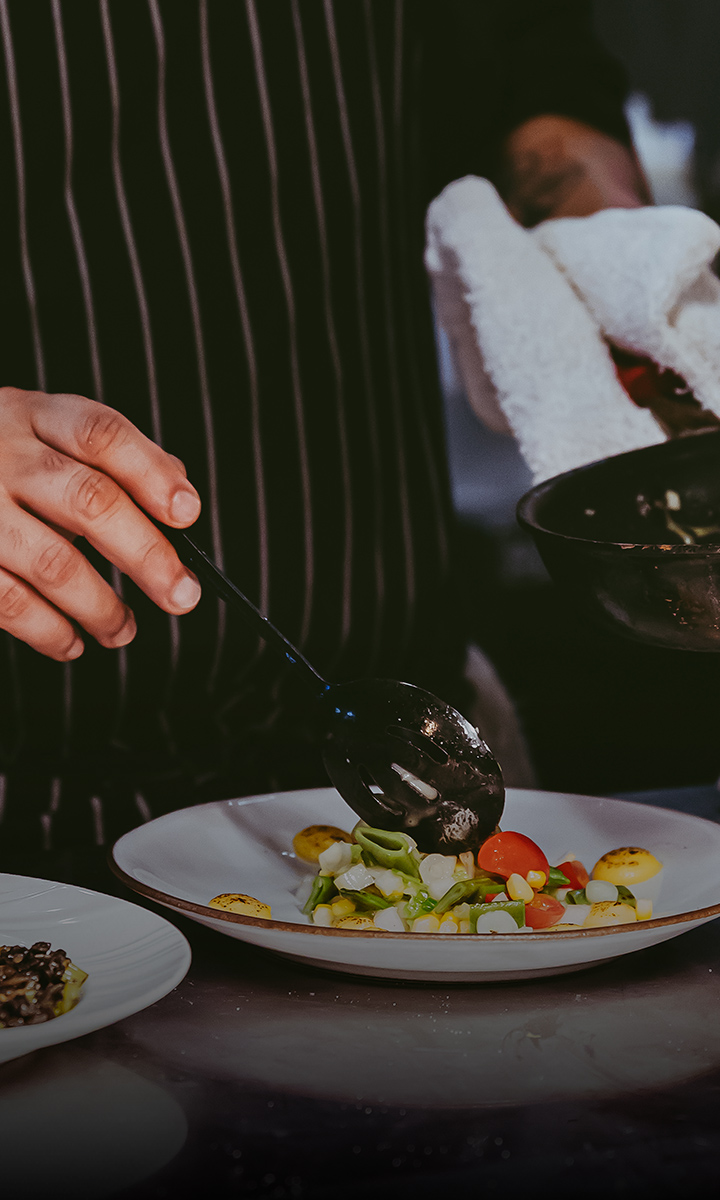 a person cooking food on a plate
