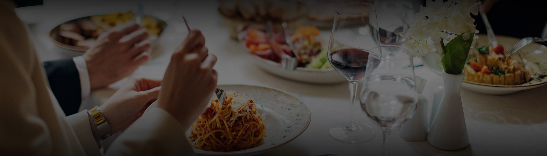 a plate of spaghetti and a glass of wine