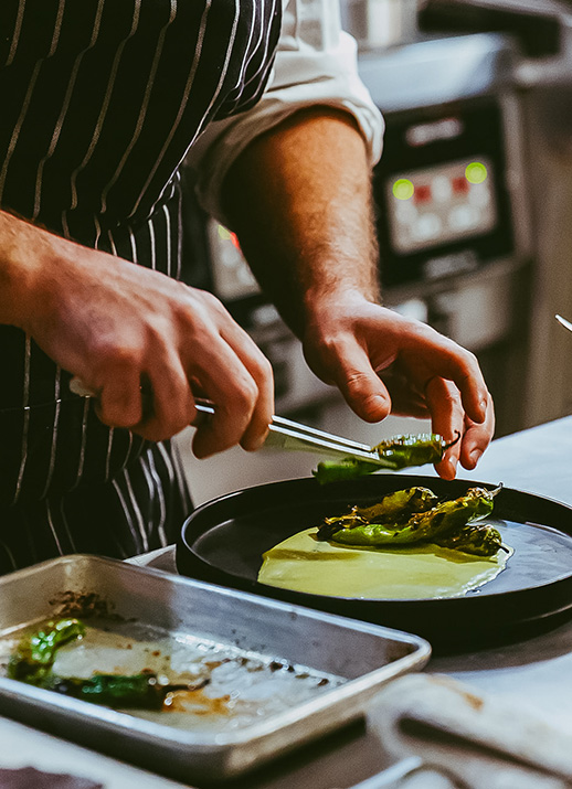 a person cooking food in a kitchen
