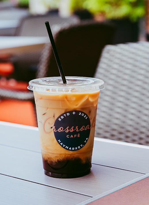 a plastic cup with a straw and brown liquid