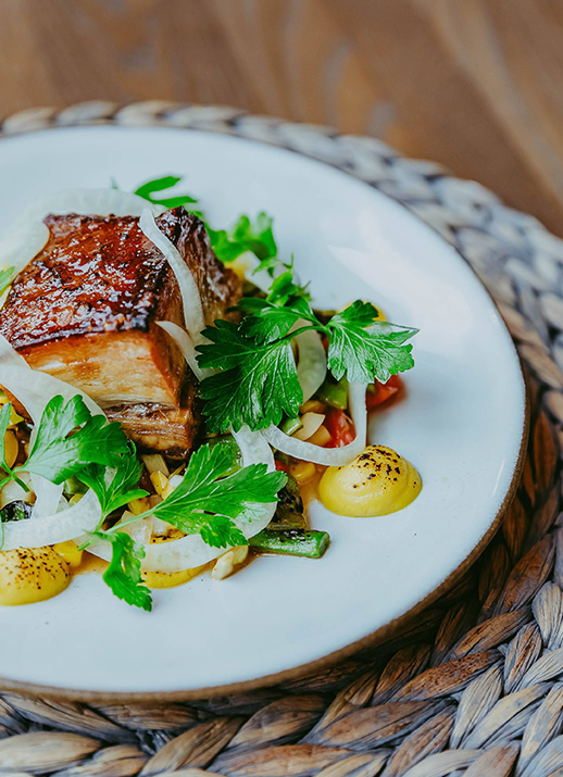 a plate of food on a wicker place mat