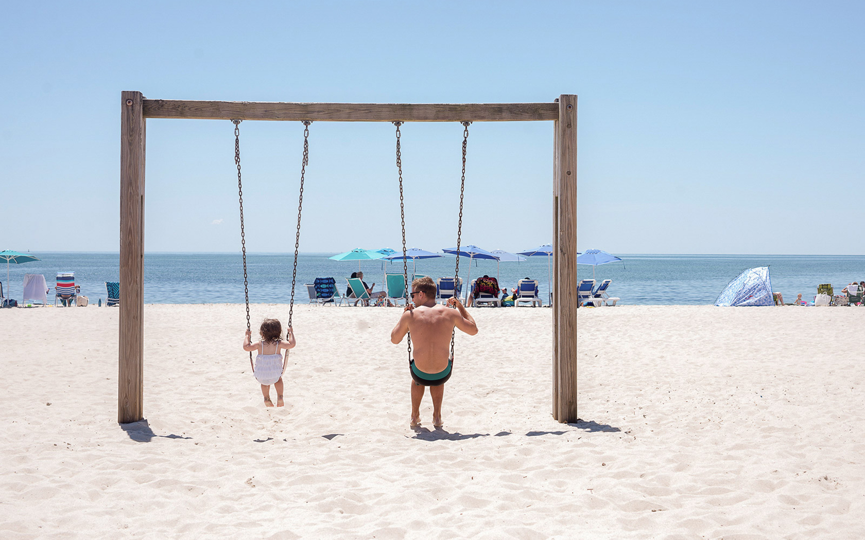 a couple of kids playing on a beach