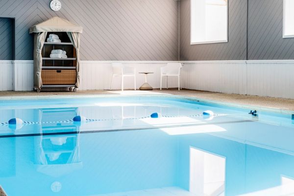 a swimming pool with a table and chairs