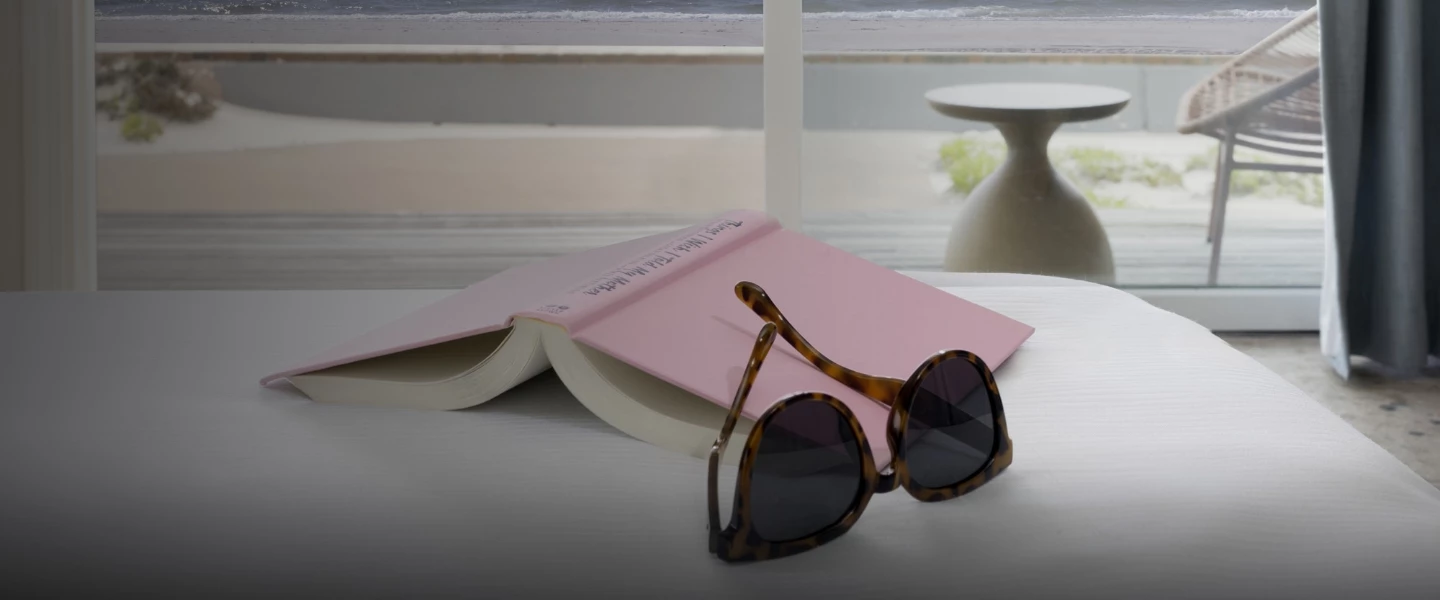 a book and sunglasses on a table