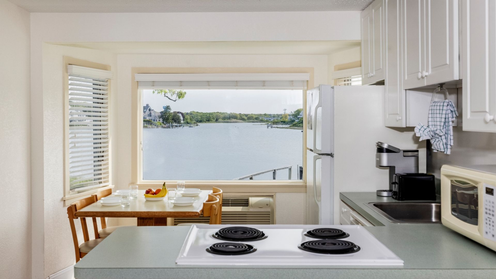 a kitchen with a view of water and trees
