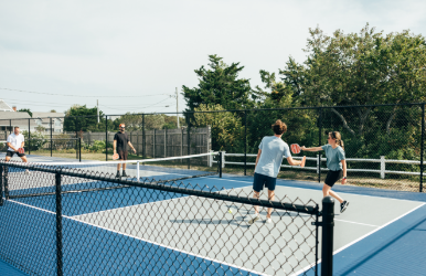 a group of people playing tennis
