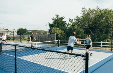 a group of people playing tennis