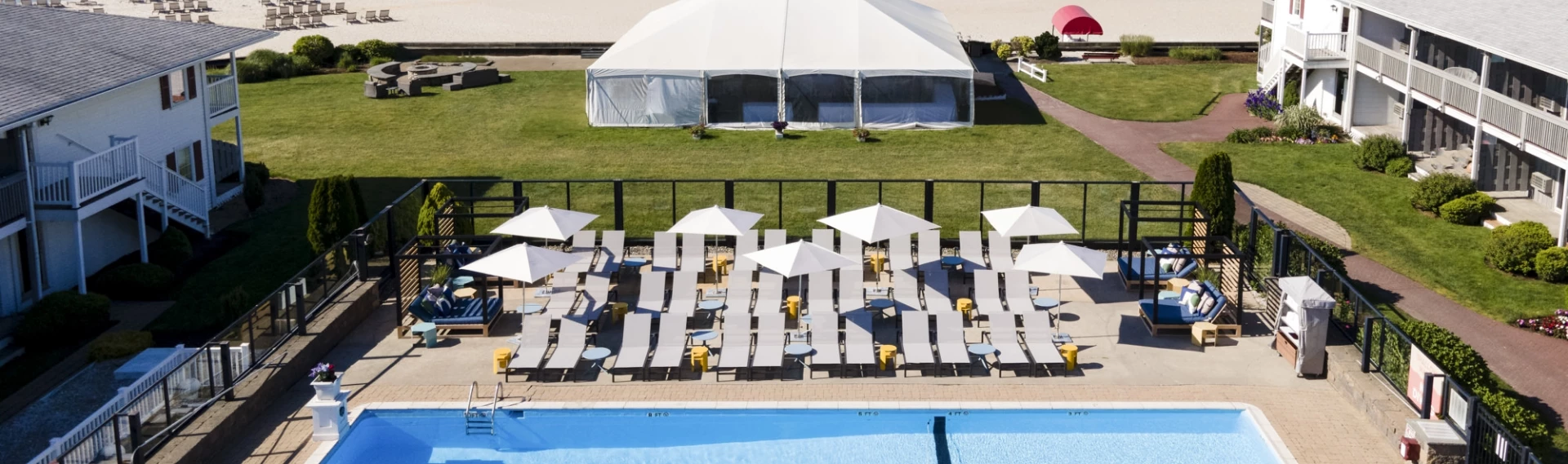 a white tent next to a pool