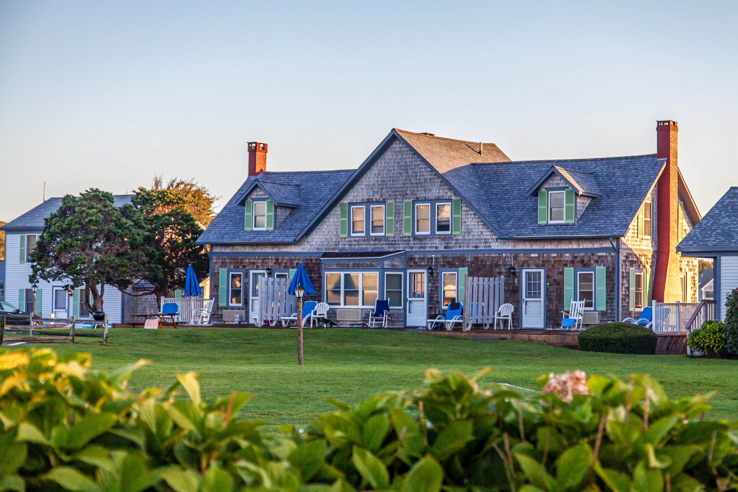 a house with lawn and chairs