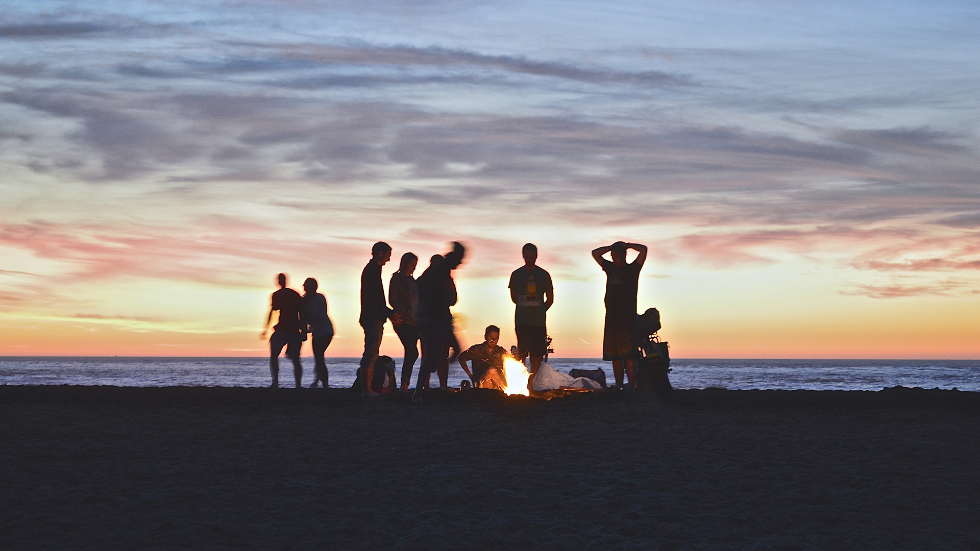 a group of people standing on a beach