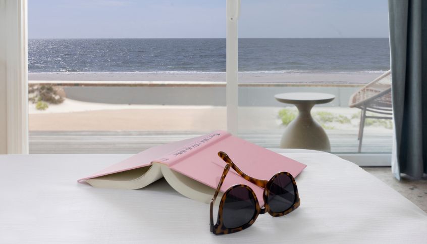 a book and sunglasses on a table