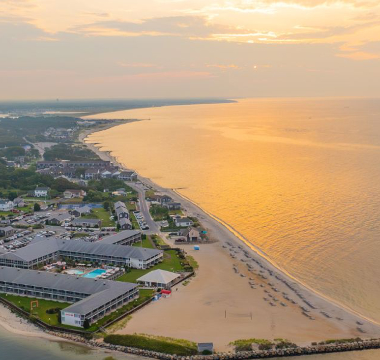 a beach with buildings and a body of water